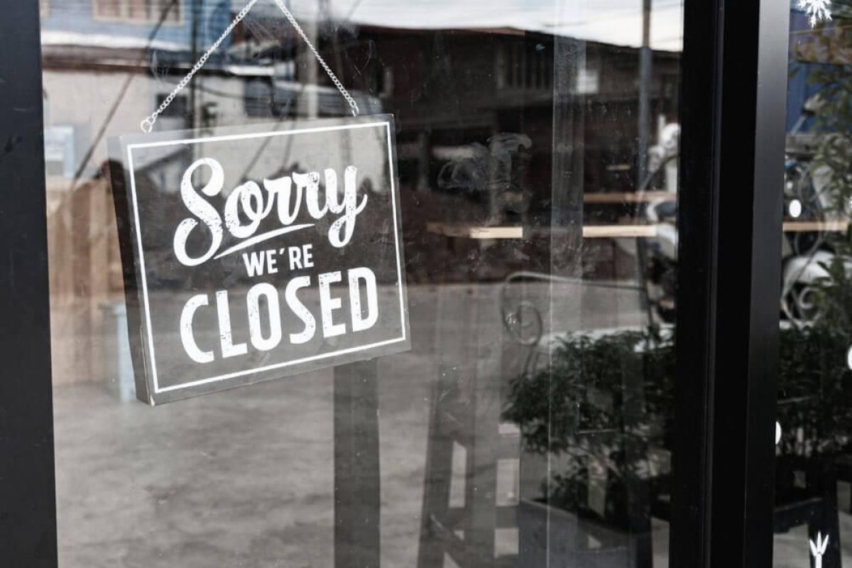 Sign on a glass door in Wilmington, NC.
