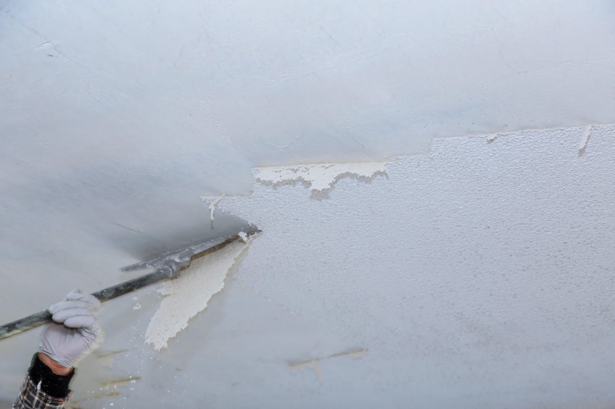 Contractor removing popcorn ceiling