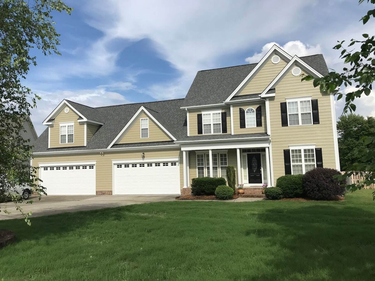 Exterior of a large yellow house.